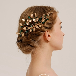 Elegant bridal hair comb with golden leaves and green crystals for wedding hairstyles