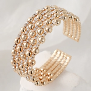 Elegant gold wide open bangle featuring four rows of beads and sparkling zircon stones
