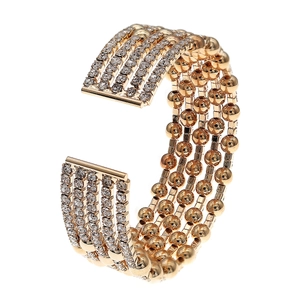 Detail of five-row gold bangle with alternating rhinestones and polished golden beads