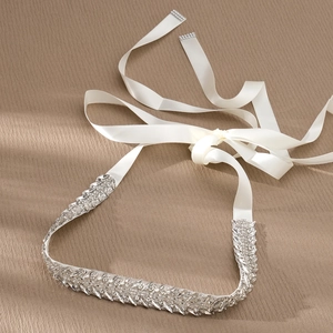 Detailed macro view of bridal sash with sparkling marquise rhinestones and white satin ribbon