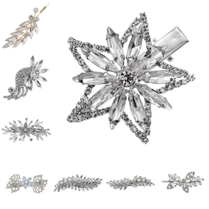 Close-up detail of silver alloy hair clips featuring snowflake and floral rhinestone designs