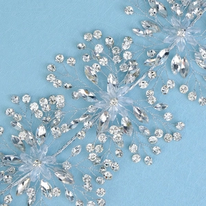 Detailed close-up of handmade silver bridal hair vine with crystals and floral accents
