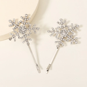 Detailed view of two silver star hair clips featuring sparkling rhinestones and crystals