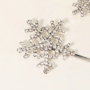Macro shot of silver snowflake hair clip with sparkling rhinestones in a refined metal base