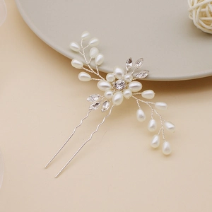 Detailed close-up of handmade bridal hair pin with pearls and sparkling crystals