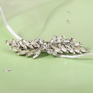 Detail of silver hair clip featuring sparkling marquise crystals in leaf design