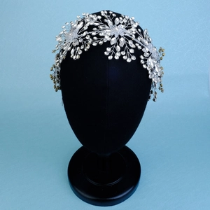 Detailed view of silver bridal headband featuring intricate crystal weave and floral design