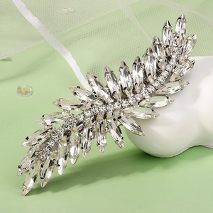 Macro shot of silver feather hair clip with brilliant marquise cut rhinestones