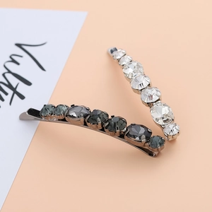 Close-up of sparkling rhinestone hair clips in clear and smoke gray with alloy base