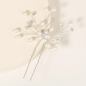 Elegant bridal hair pin with white pearls and sparkling crystals in silver floral design