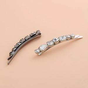 Set of 2 minimalist rhinestone hair pins in gunmetal and silver on peach background