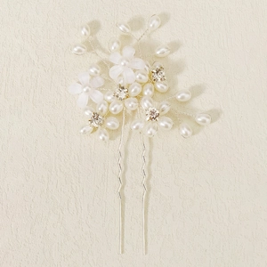 Detail of bridal hair pin with white pearls, frosted flowers, and crystals on silver wire