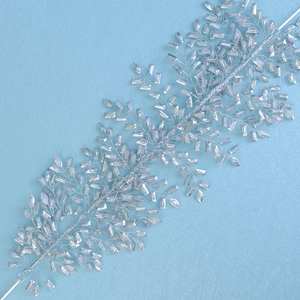 Detail of silver bridal hair vine with sparkling crystals and woven metal wire