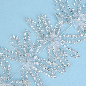 Macro shot of handcrafted silver bridal hair vine with crystal beads and floral details