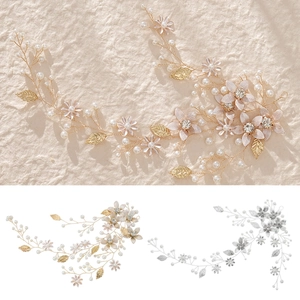 Detailed macro view of handmade bridal hair vine with pearls, rhinestones and metal leaves
