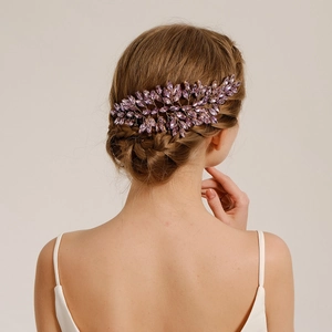 Detailed back view of bridal purple crystal hair comb woven into a braided wedding hairstyle