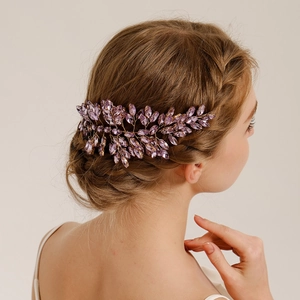 Detailed side view of purple crystal bridal hairpiece woven with gold wire on model