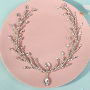 Macro view of bridal crystal forehead chain with a teardrop diamond pendant and silver vine