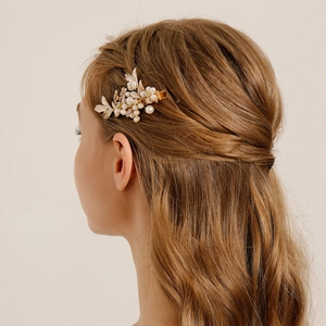 Detail of bridal hair clip with pearls and enamel leaves on a gold alloy base