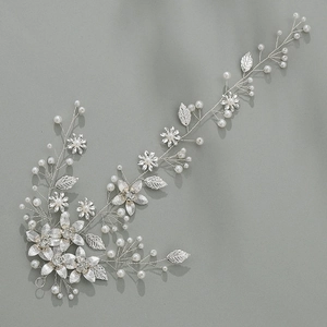Detailed close-up of bridal vine with silver leaves, metal flowers and pearls