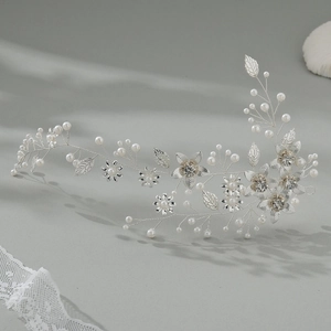 Detailed macro view of silver bridal hair vine with pearls, leaves, and rhinestones