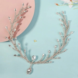 Close-up of bridal rhinestone forehead chain with silver vine design and teardrop pendant