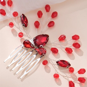 Detail of red crystal bridal hair comb with silver wire floral accents and metal tines