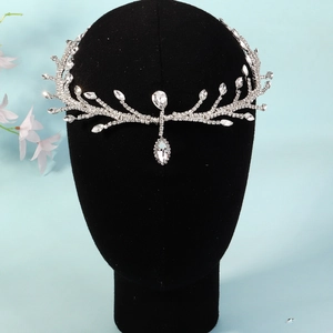Close-up of silver branch bridal headpiece with sparkling rhinestones and drop pendant