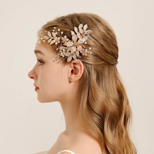 Detail of luxury gold floral bridal hair clip with white pearls and crystals on hair