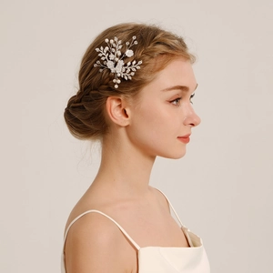 Detail view of handmade bridal hair pin with white flowers and pearls on silver wire