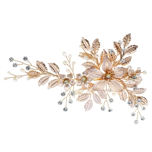 Detail of luxury bridal hair comb with gold metal flowers, pearls and rhinestones