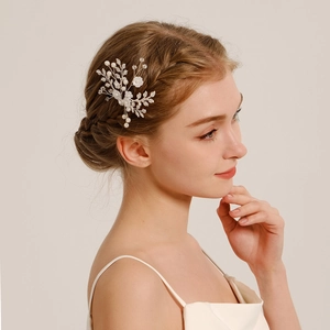 Detail of handcrafted floral hair pin with white flowers and pearls on silver wire