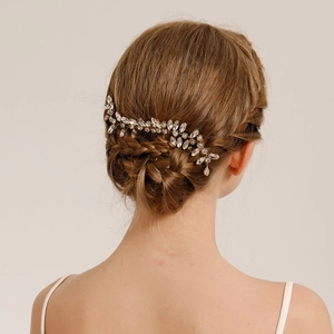Detailed back view of a leaf rhinestone hair comb set in an elegant bridal updo