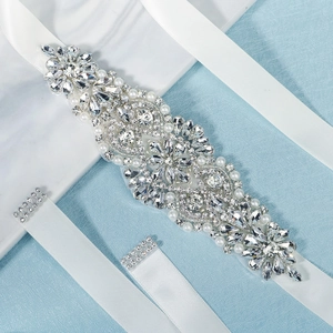 Luxury bridal belt with sparkling rhinestones and pearls on white satin ribbon