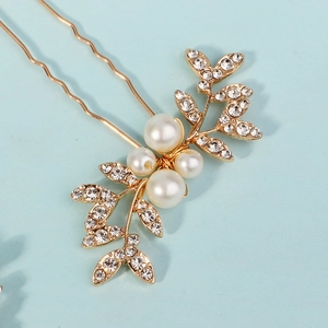 Detail of bridal hair pin with white pearls, gold leaves, and crystal rhinestones