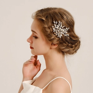 Close-up of a silver bridal hair comb with hand-woven pearls and marquise rhinestones