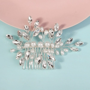 Detailed view of silver bridal hair comb with woven pearls and marquise rhinestones