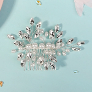 Detail of silver bridal hair comb with hand-woven pearls and marquise rhinestones