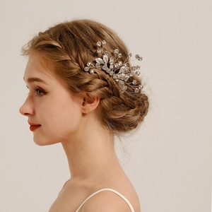 Detail of bridal hair comb with silver leaves and rhinestones on woman's hair