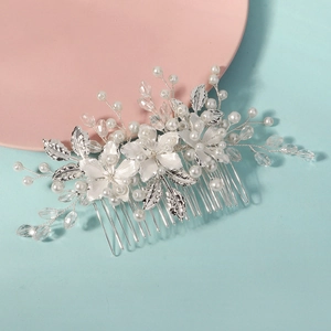 Detail of silver bridal hair comb with pearls, crystals, and delicate alloy flowers