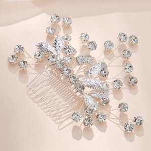 Close-up of bridal hair comb with silver leaves and sparkling crystal rhinestones