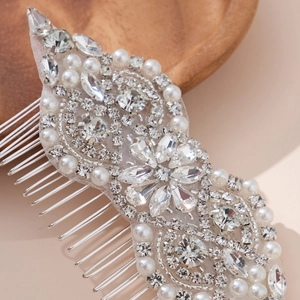 Macro view of handmade bridal hair comb with glittering rhinestones and white pearls