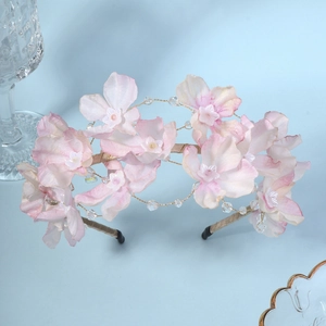 Floral wedding headband with pink fabric flowers and crystal beads on a gold wire frame