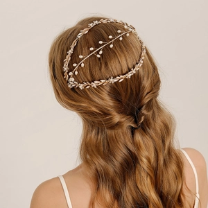 Elegant bridal headpiece with white pearls and gold leaves for wedding hair styling