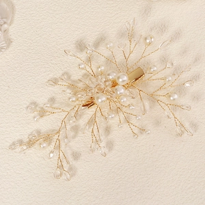 Detail of handmade gold wire hair clip with pearls and crystals for bridal hair