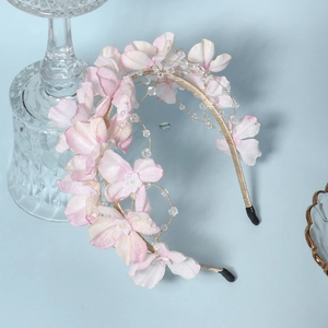 Elegant handmade floral headband with pink petals and crystal beads for forest weddings