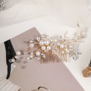 Elegant bridal hair comb with pearls and crystals on a golden wire for wedding styling