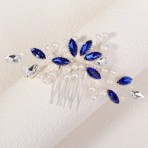 Detailed close-up of bridal hair comb with blue marquise crystals and white pearls