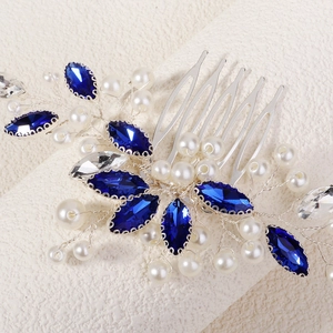 Detailed macro view of bridal hair comb with blue marquise crystals and white pearls