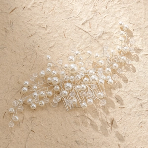 Detail of bridal hair comb with pearls and marquise rhinestones on silver wire